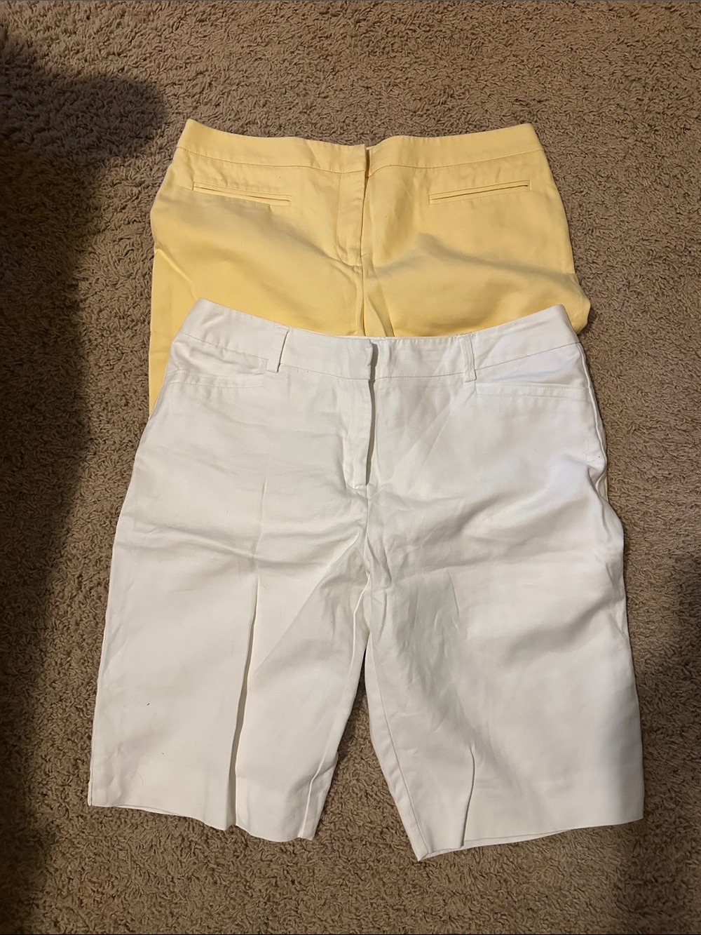 Two pairs of ladies Chico size 1.5 knee length shorts, white, and yellow